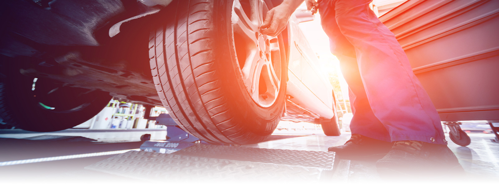 Photo of mechanic working on car's tire.